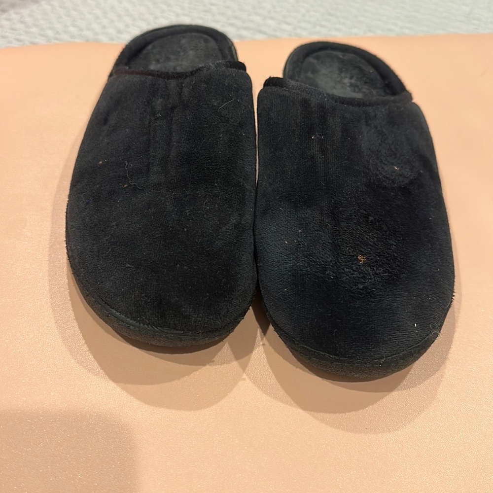 Used pair of Isotoner size 7.5 hard rubber soled slide on slippers.
